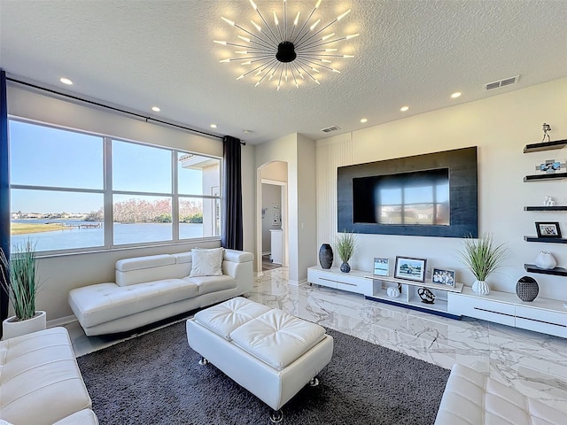 living room featuring a notable chandelier and a textured ceiling