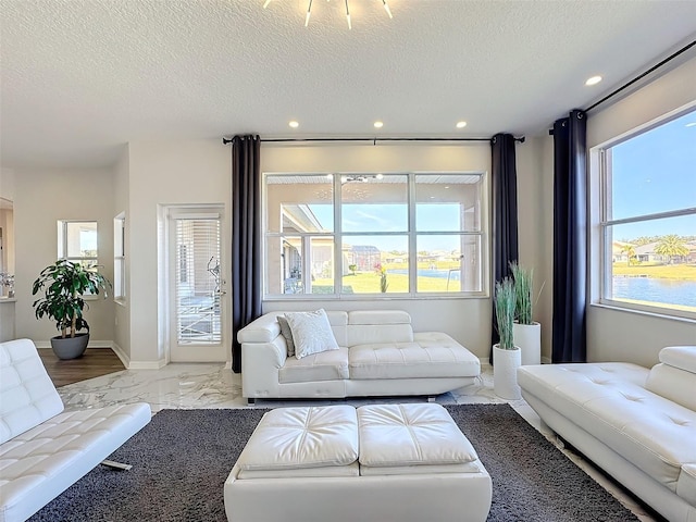 living room featuring a wealth of natural light and a textured ceiling