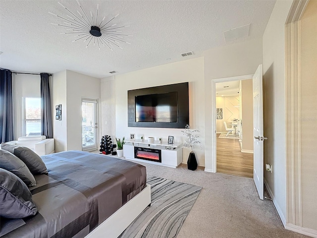 carpeted bedroom with a textured ceiling