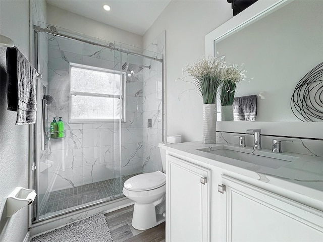 bathroom featuring vanity, hardwood / wood-style floors, toilet, and an enclosed shower