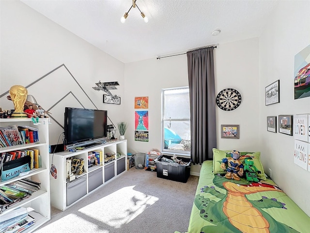 bedroom with carpet and a textured ceiling