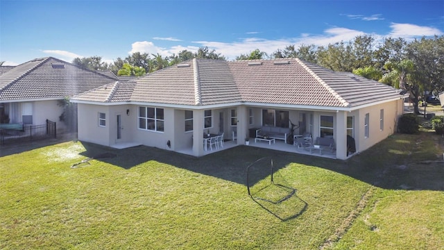 rear view of house featuring a patio and a lawn