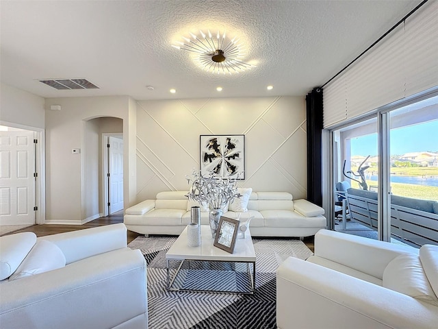 living room featuring hardwood / wood-style floors and a textured ceiling