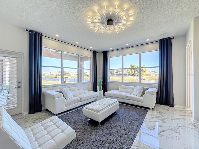 living room featuring a notable chandelier and a textured ceiling