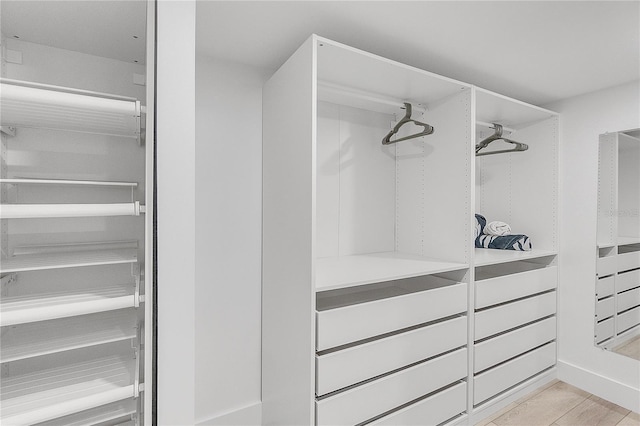 walk in closet featuring light hardwood / wood-style flooring