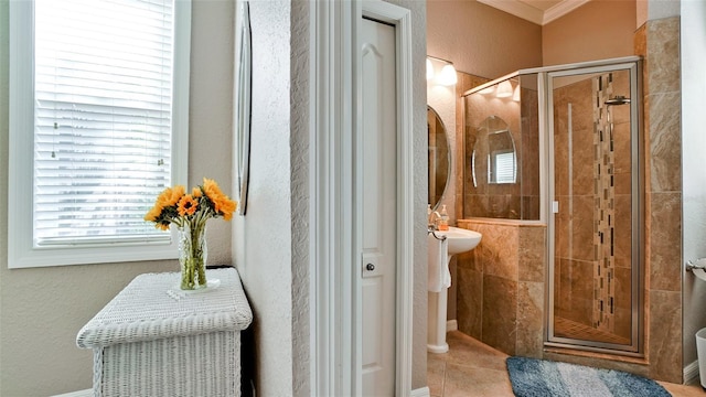 bathroom featuring crown molding and an enclosed shower