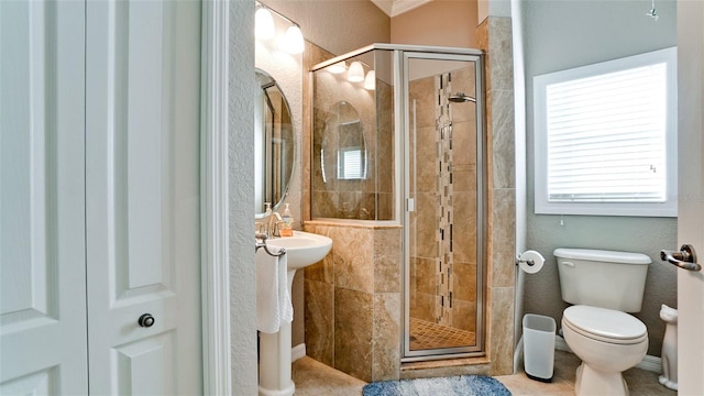 bathroom featuring an enclosed shower, tile patterned flooring, and toilet