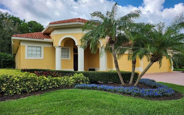 mediterranean / spanish-style home with a garage