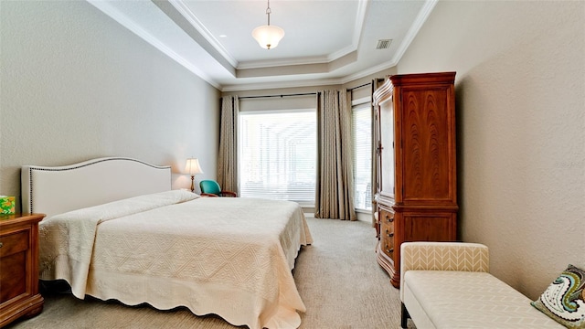 carpeted bedroom with a raised ceiling and crown molding