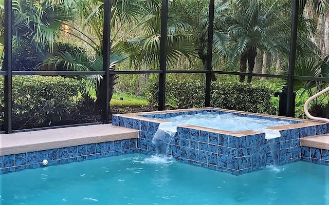 view of swimming pool featuring an in ground hot tub and pool water feature