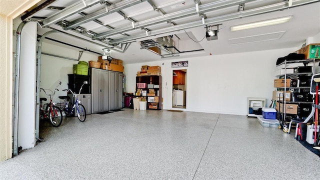 garage featuring a garage door opener and washer / clothes dryer