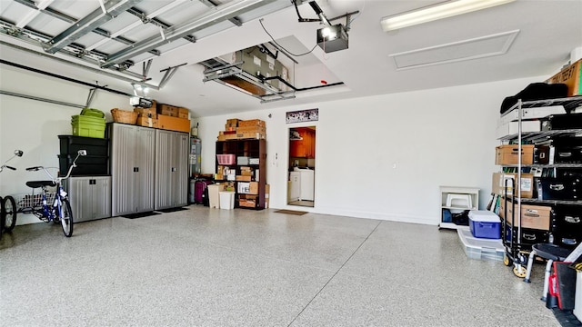 garage featuring washer / dryer and a garage door opener