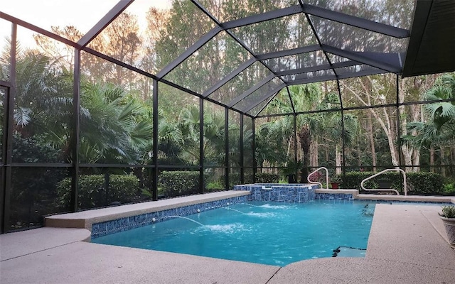 view of swimming pool with pool water feature, a lanai, and an in ground hot tub