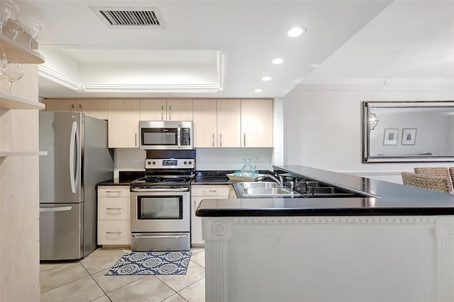 1200 E Peppertree Ln Unit 607, Sarasota, FL 34242 - kitchen with stainless steel appliances, a peninsula, recessed lighting, light tile patterned floors, and a tray ceiling