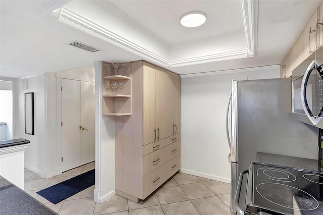 1200 E Peppertree Ln Unit 607, Sarasota, FL 34242 - kitchen featuring a raised ceiling, electric range oven, light tile patterned floors, and stainless steel microwave