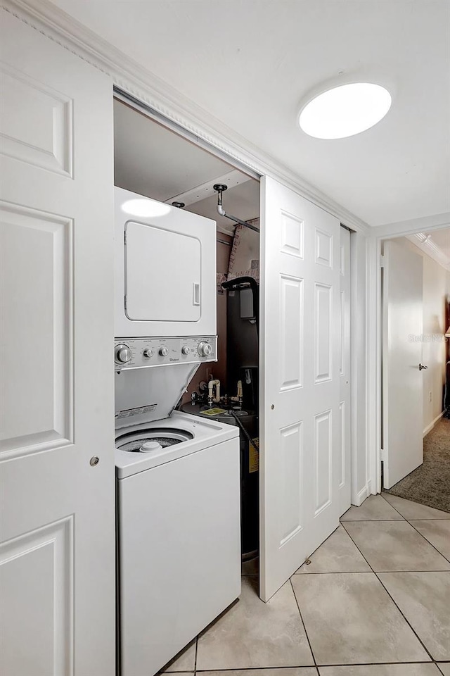 1200 E Peppertree Ln Unit 607, Sarasota, FL 34242 - laundry area with stacked washer and clothes dryer and light tile patterned flooring