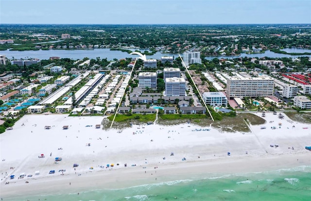 bird's eye view featuring a water view and a beach view