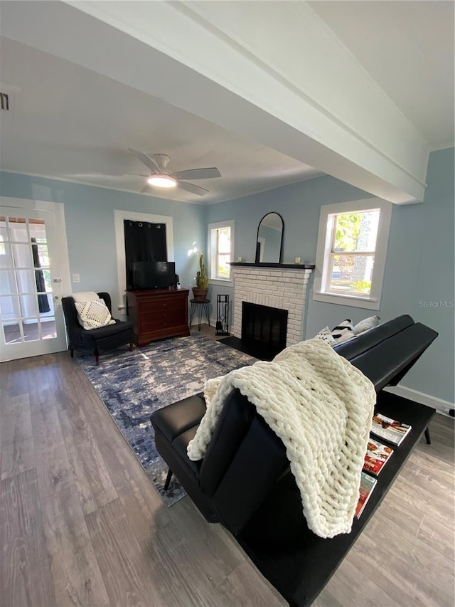 living room with a fireplace, hardwood / wood-style flooring, and ceiling fan