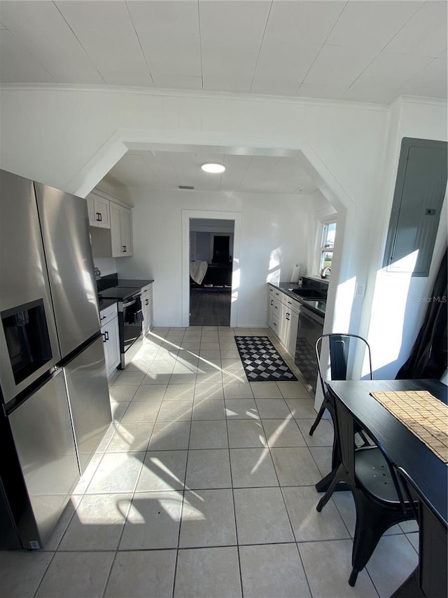 222 27th St W, Bradenton, FL 34205 - kitchen featuring stainless steel appliances, white cabinetry, dark countertops, and ornamental molding