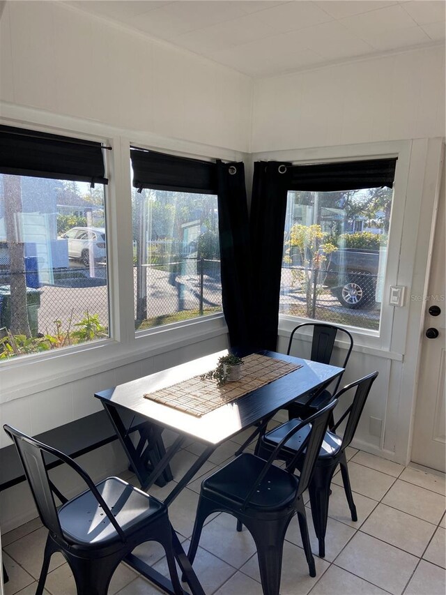 dining room with light tile patterned floors and a healthy amount of sunlight