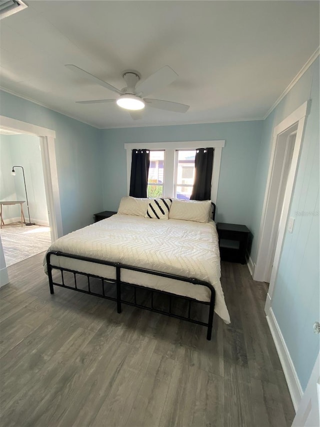 bedroom with ceiling fan, crown molding, and hardwood / wood-style flooring