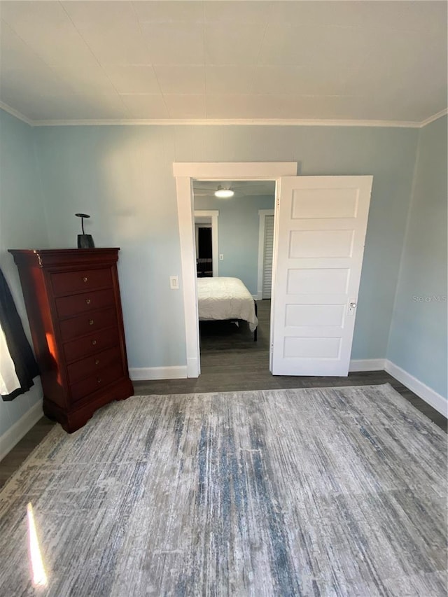 unfurnished bedroom featuring crown molding and wood-type flooring