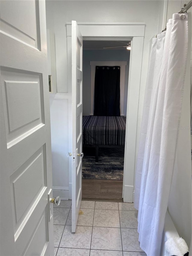 bathroom with ceiling fan, hardwood / wood-style floors, and shower / tub combo with curtain