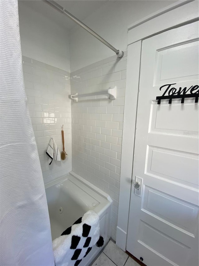 bathroom with tile patterned flooring and shower / bath combo