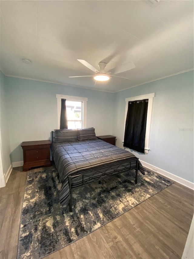 bedroom with ceiling fan, hardwood / wood-style floors, and ornamental molding