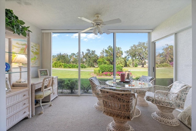 sunroom with a wealth of natural light and ceiling fan