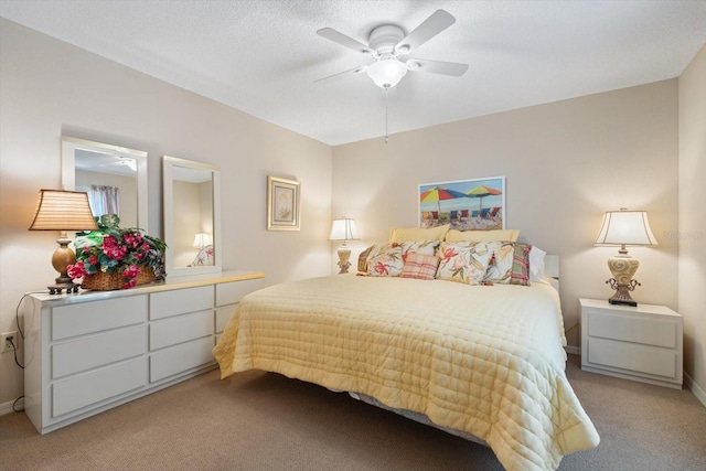 carpeted bedroom with a textured ceiling and ceiling fan