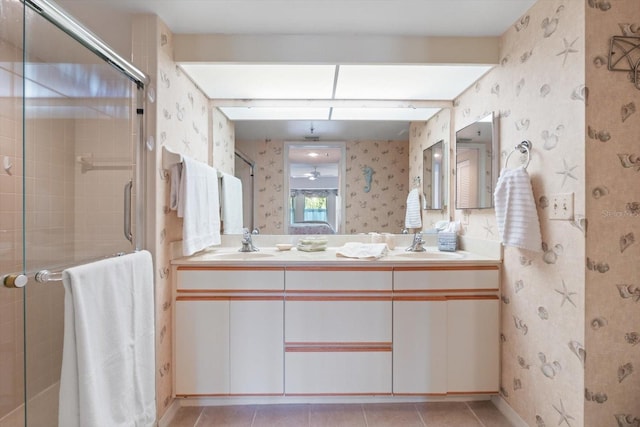 bathroom featuring tile patterned flooring, vanity, and walk in shower