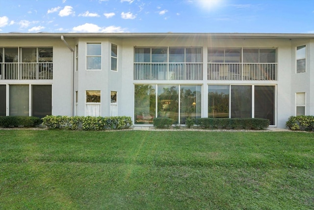 rear view of house with a yard