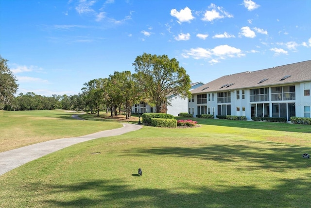 view of property's community featuring a yard