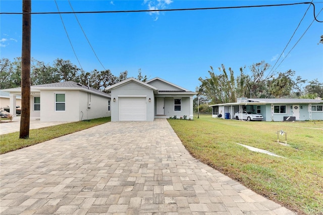 ranch-style home featuring a garage and a front yard