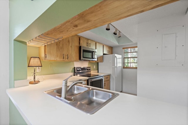 kitchen with sink, electric panel, a textured ceiling, track lighting, and appliances with stainless steel finishes