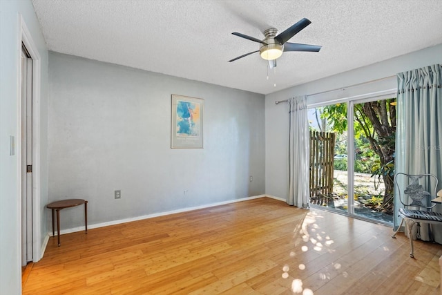 unfurnished room featuring ceiling fan, light hardwood / wood-style floors, and a textured ceiling