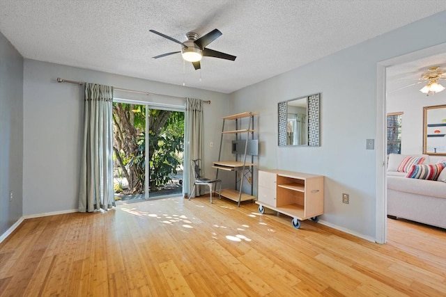 unfurnished room with hardwood / wood-style floors, a textured ceiling, and ceiling fan