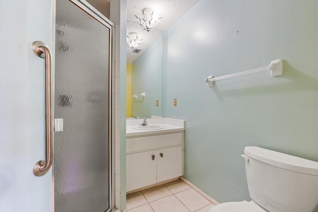 bathroom featuring tile patterned floors, vanity, toilet, and an enclosed shower