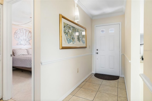 doorway to outside featuring light tile patterned floors and crown molding