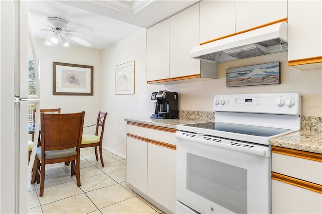 kitchen with ceiling fan, white cabinets, light tile patterned flooring, and white appliances