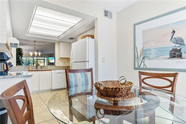 kitchen featuring white cabinetry, dishwasher, sink, a chandelier, and light tile patterned floors