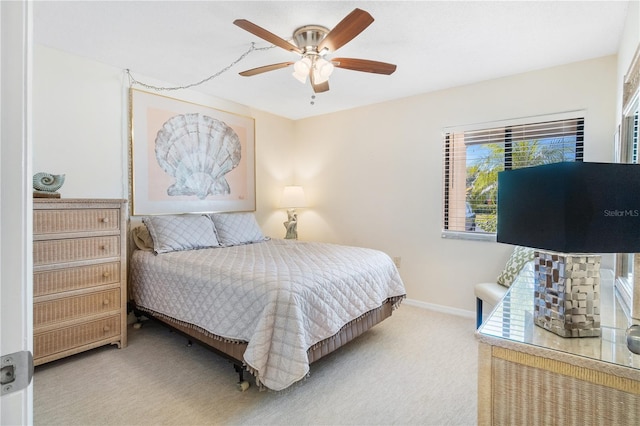 bedroom featuring ceiling fan and carpet