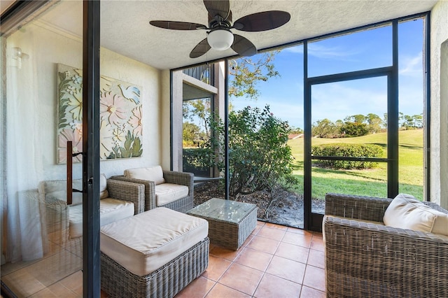 sunroom featuring ceiling fan