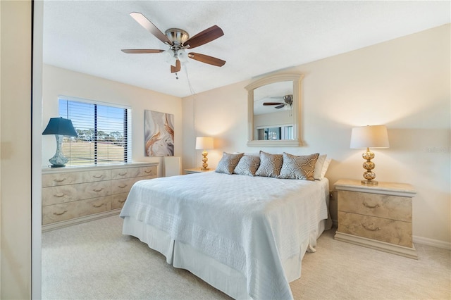 bedroom with ceiling fan and light colored carpet