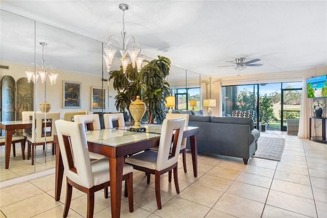 tiled dining space with ceiling fan with notable chandelier and crown molding