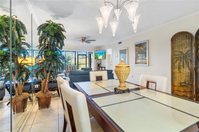 tiled dining room with ceiling fan with notable chandelier and ornamental molding