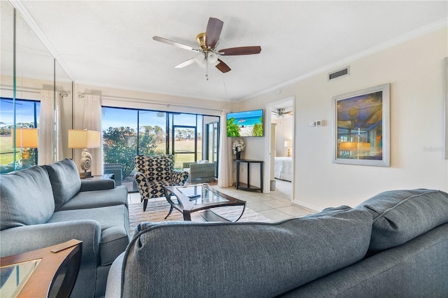 living room with ceiling fan, crown molding, and light tile patterned floors