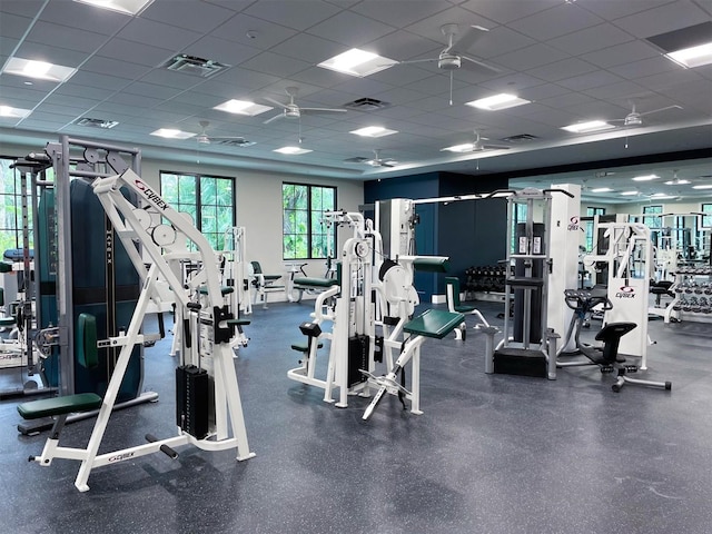 gym featuring a paneled ceiling and ceiling fan