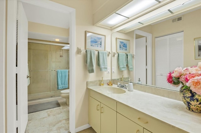 bathroom featuring vanity, toilet, and walk in shower